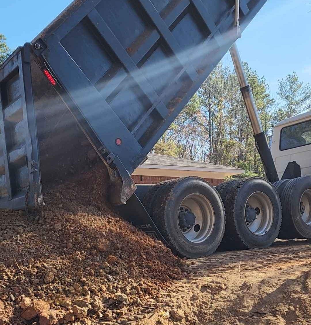 Dump truck delivering fill dirt
